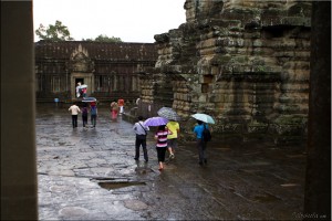 Colourful umbrellas in a wet courtyard, Angkor Wat