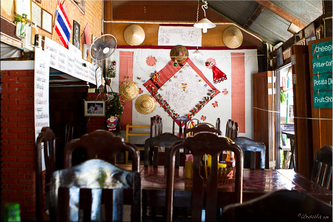 Inside a cafe: Chairs, quilting and wicker-work  on the walls