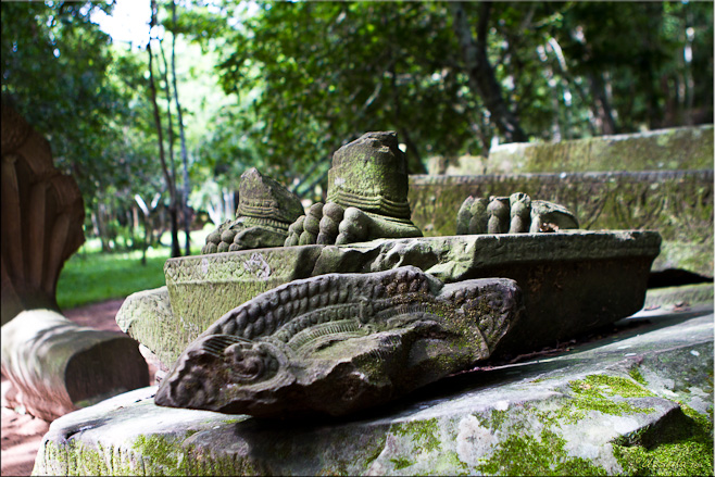 Moss-covered broken stones with the sculpted clawed feet of a mythical creature