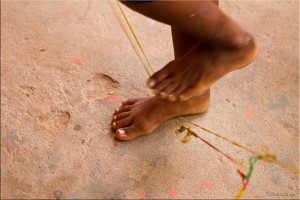 Detail: Young girl's feet on skipping elastics