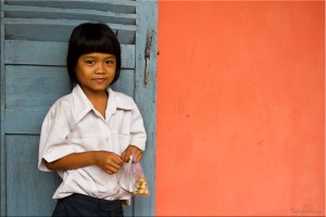 Portrait: Young Khmer girl with a plastic food bag.