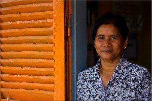 Portrait: Khmer teacher in her classroom doorway.