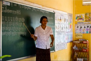 Teacher with a pointer teaching khmer letter combinations.