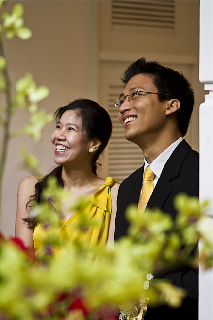 Portrait: Young Thai man and woman, smiling.