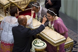 Two thai elders anoint two younger thai newlyweds.