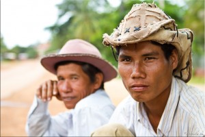 Portrait: Two khmer men in cotton cowboy hats.