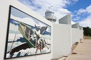Ceramic mosaic mural of an 1800s wooden whale boat and a humpback whale.