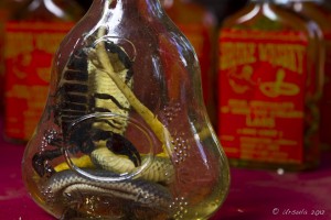 Large black scorpion and a cobra in a whiskey bottle.