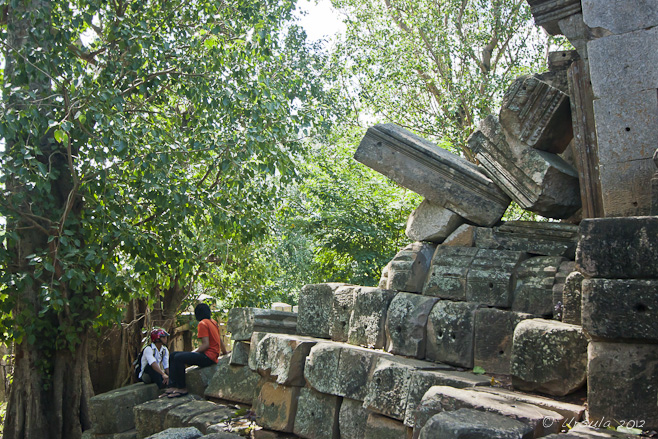 Two young Khmer men at an Angkor-period ruin.