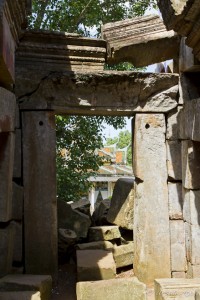 Looking through old Khmer ruins at a new way/temple.