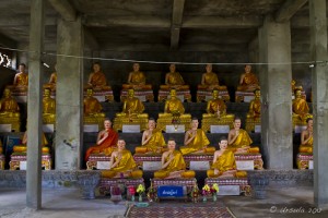 A concrete room full of buddha or abbot statues