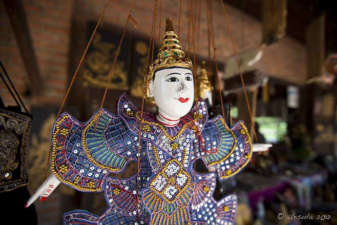 White-faced, delicately painted Thai marionette in sequinned costume