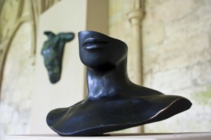 Sculptures: partial female head; partial male torso.