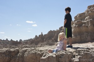 Young blond child climbing through badlands.