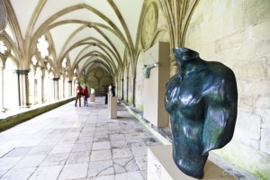The cloisters of Salisbury Cathedral with a sculpture of a partial male torso.