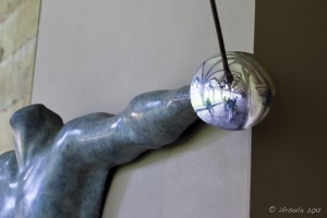 Sculpture of a male arm holding an epee.