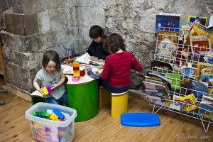 Three childdren in a play corneer