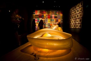 Warmly lit cream yellow glass bowls - Native American tapestries in the background.