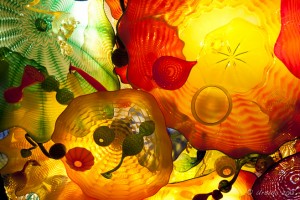 Colourful glass forms with light shining through.