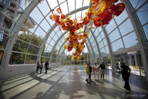 Large glass and chrome glasshouse with suspended orange and yellow glass 
