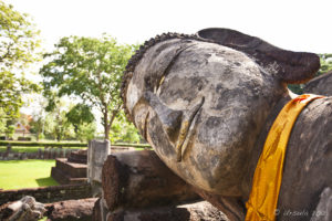Large stone head of a reclining Buddha.