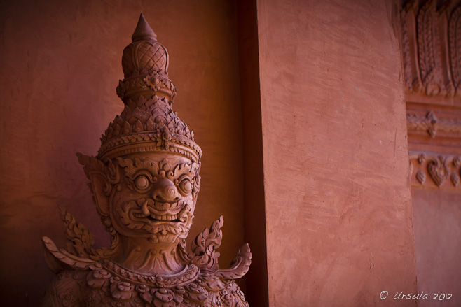 Head shot of a red clay temple-door guardian, Yaak or Dvarapala Yaksha.