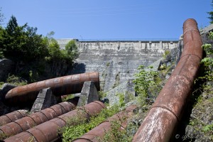Dam wall and rusty pipes. Slave Falls Powerhouse