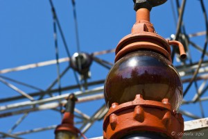 Red glass electrical Insulator against a blue sky. Stave Falls Powerhouse