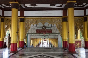 Tall red and gold pillars in an ornate entry hall, Shwemawdaw Temple.