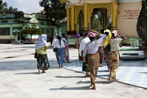 Burmese women walking with their heads covered against the sun, Shwemawdaw Temple, Bago.