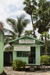 Small green building advertising fortune telling services: Shwemawdaw Temple