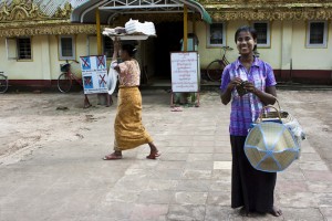 Portrait: young burmese gift seller in the Shwethalyaung courtyard.