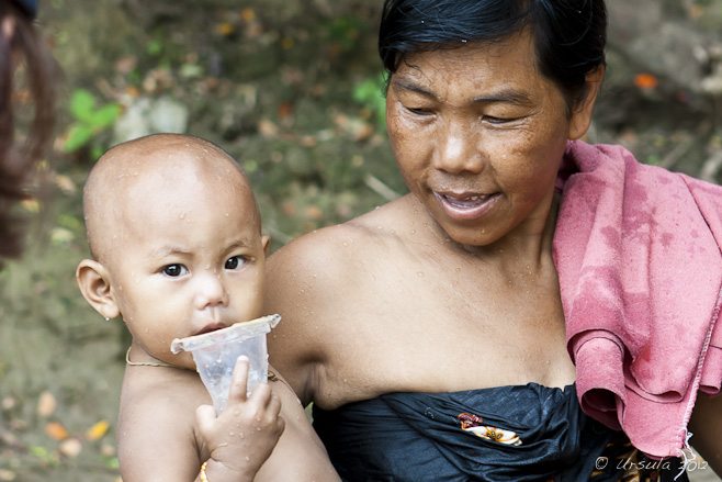 Portrait: Burmese woman and baby, wet from their morning bath.