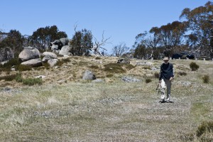 Man in cowboy hat walking over grasslands, Rennix Gap.