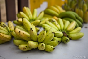 Fresh hands of bananas on a table.