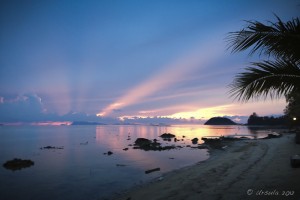 Delicate blue and yellow sunset over calm seas and rocks, Ang Thong, Koh Samui.