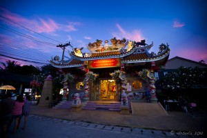 Electric blue sky with touches of pink over an ornate Chinese Buddhist temple Sunset, Mae Nam, Thailand.