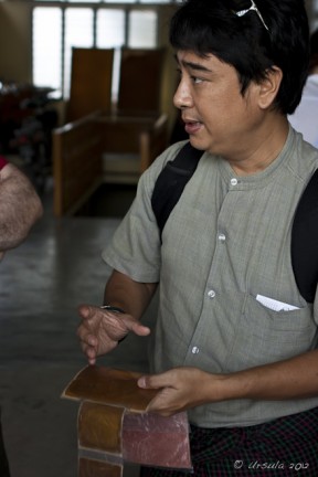 Burmese male explaining gold leaf