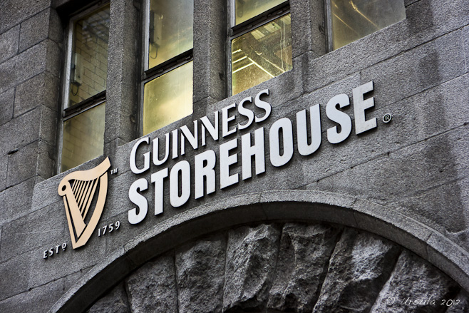 The harp and "Guinness Storehouse" name over a brick archway; Dublin, Ireland.