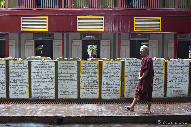 An elder monk walking on the sidewalk, Mahagandayon Monastery