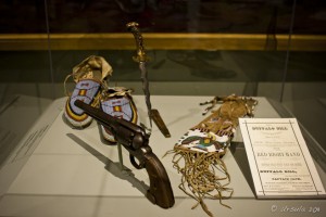 Buffalo Bill Museum (Cody) case: Revolver, beaded moccasins, gauntlets and program from the 