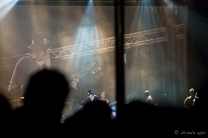 Santana - in person on a distant stage, and projected on a large screen behind.