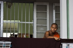 A Theravada Monk on a balcony, Mahagandayon Monastery