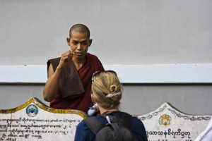 Burmese Theravada Monk talking to a blond woman, Mahagandayon Monastery