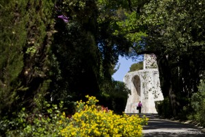View through rich foliage, up a path to La Tour Magne