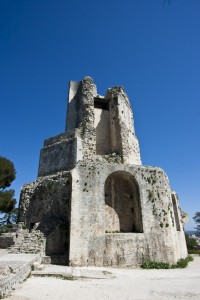 Ruins of La Tour Magne, Nîmes, against a blue sky.