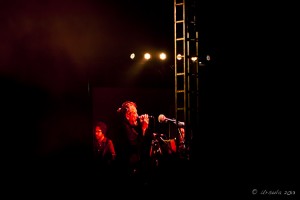 Dark stage: red light on Robert Plant singing