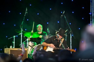 Portrait: Tony Joe White on guitar, drummer behind