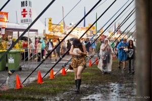 Festival scene: people in raincoats and boots, in water and mud. Byron Bluesfest 2013