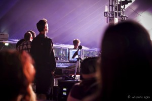 Silhouetted technicians at a soundstage in low light.